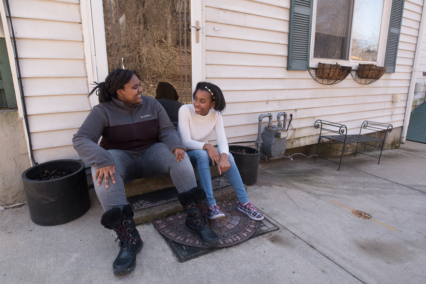 Monet Spencer, 18, left, sits with her best friend, Maya Smallwood, 18, at her North Side home where Maya and her mother took Spencer in to live after her mother died and she was left homeless. 