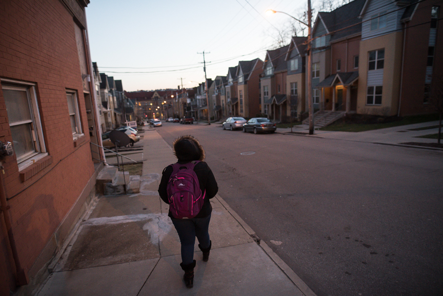 Monet Spencer, 18, walks home from her job tutoring at Pittsburgh Miller PreK-5 in Pittsburgh's Hill District on February 13, 2017. 