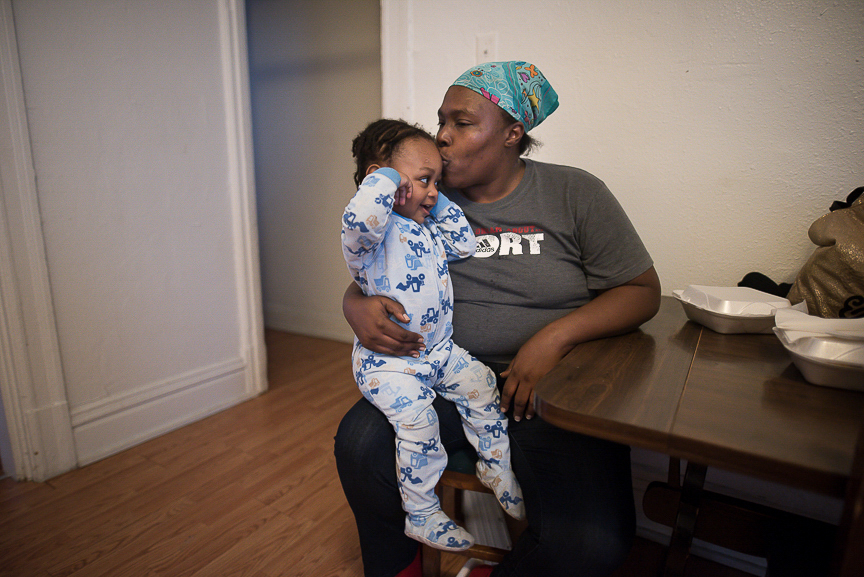 Ronnika Baker, 36, holds her grandson, Dorian, 2, in the dining room of their Braddock home on Feb. 28, 2017.