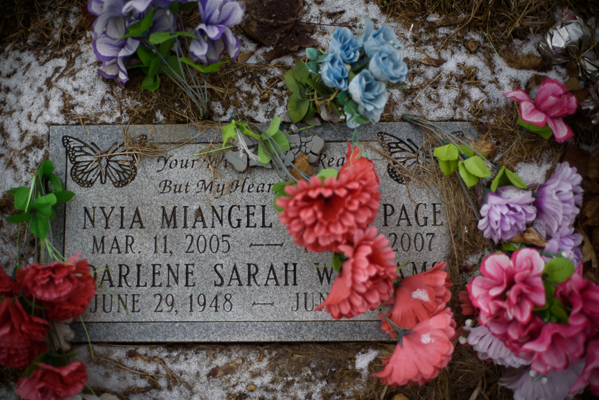  Nyia Page's headstone sits in a dusting of snow and surrounded by fake flowers in Fairview Cemetery on Feb. 25, 2018, in McKeesport, Pa.   