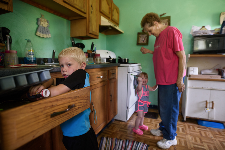  Cameron Gorman, 3, searches for a butterknife as his great-grandmother, Patricia Savulchak, 73, tends to his one-year-old sister, Layla, at her house on June 10, 2017 in Esplen, a neighborhood in Pittsburgh, Pa. Savulchak has kinship caregiver statu