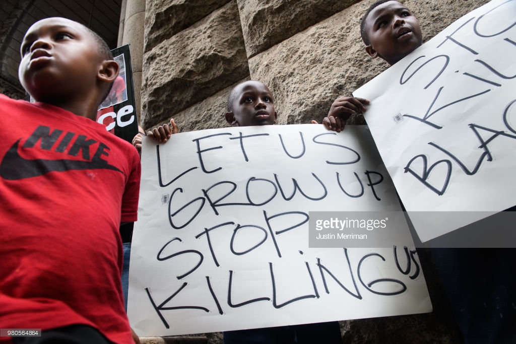  Lorde Watkins, 6, left, and his brothers, Legend, 9, center, and Maceo, 10, right, join over 200 people gathered for a rally to protest the fatal shooting of an unarmed black teen at the Allegheny County Courthouse on June 21, 2018 in Pittsburgh, Pe