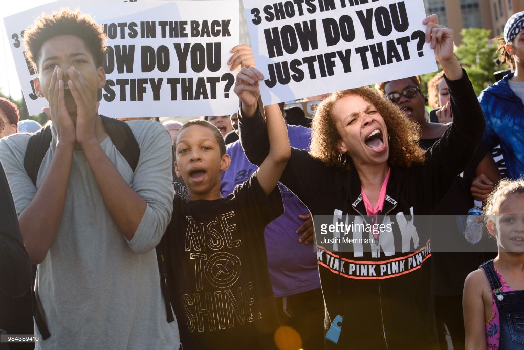  Christian Carter, 18, of East Liberty, Pa., left, marches with Marie Hudzinski and her children, Trayce, 13, and Alisia, 7, cousins of Antwon Rose II, as they join a protest a day after the funeral of Rose on June 26, 2018 in Pittsburgh, Pennsylvani