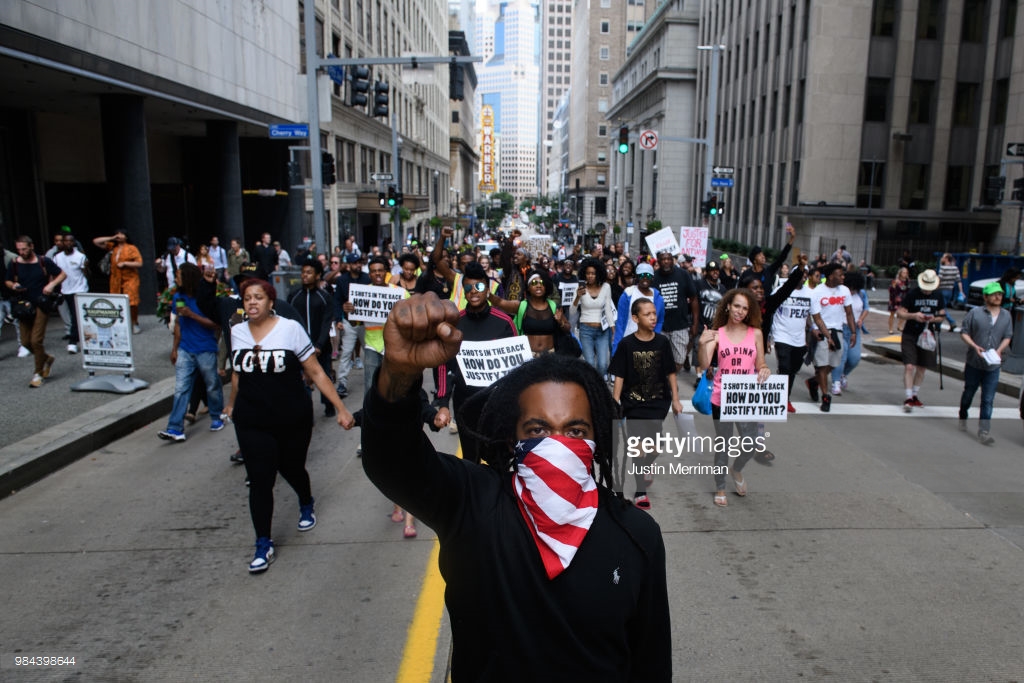  Trey Willis, 32, of Washington, Pa., marches during a protest a day after the funeral for Antwon Rose II on June 26, 2018 in Downtown, Pittsburgh, Pennsylvania. Rose was killed by an East Pittsburgh police officer on Tuesday, June 19 when he fled on