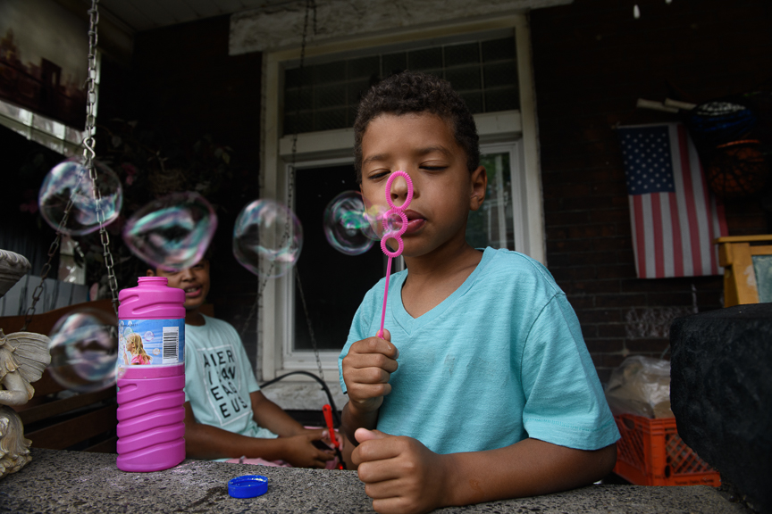  Clark Cannon, 5, blows bubbles on the front porch of his home on June 24, 2018 in East Pittsburgh, Pa.  