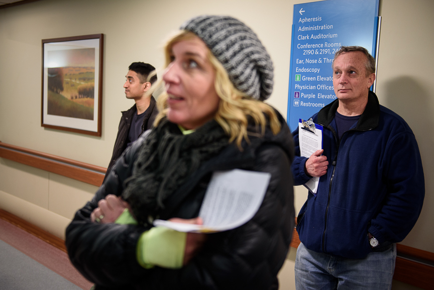  Dr. Jim Withers (right) stands with Janice Kochik, a nurse practitioner (center), and Joe Tholany, a first-year medical resident, as they wait for an elevator in a hospital prior to visiting a former patient of his on Jan. 17, 2018.  