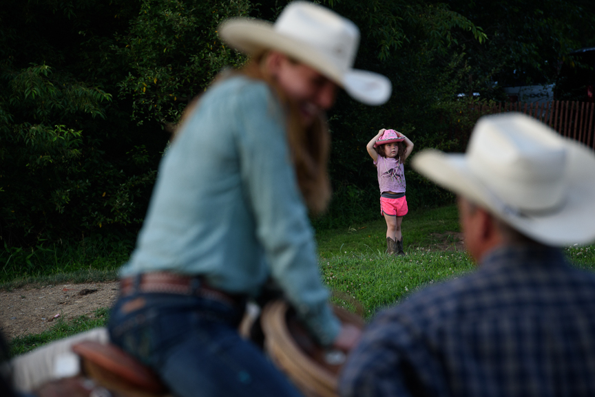  Beth Haifley, 5, of Baltimore, Md., watches competitors talk at the Fort Armstrong Championship Rodeo on Friday, July 13, 2018 at the Crooked Creek Horse Park in Ford City, Pa. 