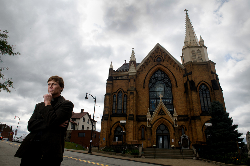  The Rev Michael Stumpf stands outside of St Mary of the Mount Church on Friday, October 12, 2018 in Pittsburgh, Pa. Stumpf has found it ‘deeply painful’ to be confronted by angry and suspicious parishioners. But it was also appropriate, he said. 