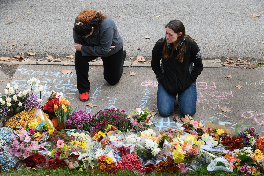  Holly Donahoo, left, and Diana Ciniello, right, both of Shadyside kneel and cry at a makeshift memorial. 