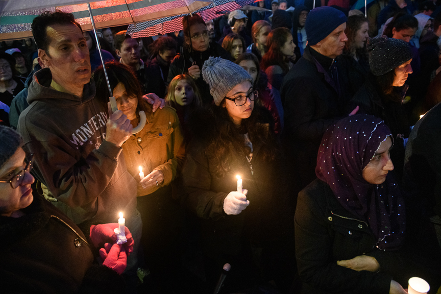  Mourners join a vigil on Saturday evening in Squirrel Hill. 