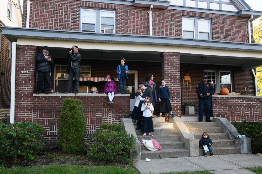  People watch as several thousand people pass by their home in a solidarity march in response to the visit by President Trump to Pittsburgh in the wake of the Tree of Life Synagogue shooting on Tuesday, October 30, 2018 in Pittsburgh's Squirrel Hill 