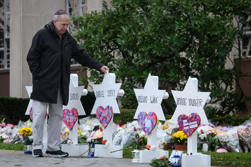  Bob Goldstein, 71, of Squirrel Hill walks past memorials in front of the Tree of Life Synagogue on Monday, October 29, 2018. Goldstein has attended the Tree of Life for his entire life and knew 8 of the victims.   