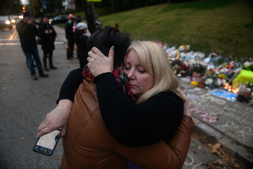  Sheila May-Stein of Wilkins Township hugs a fellow mourner after a supporter of President Trump upset her as she visited a makeshift memorial near the Tree of Life Synagogue. 