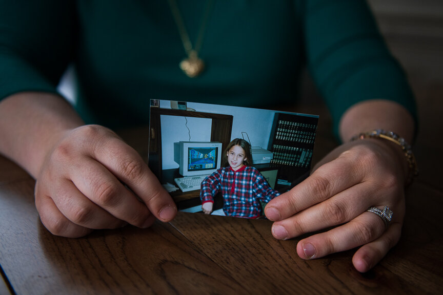  Amanda Dorich holds a photo of herself from the age when she was a patient and victim of Dr. Johnnie Barto.  