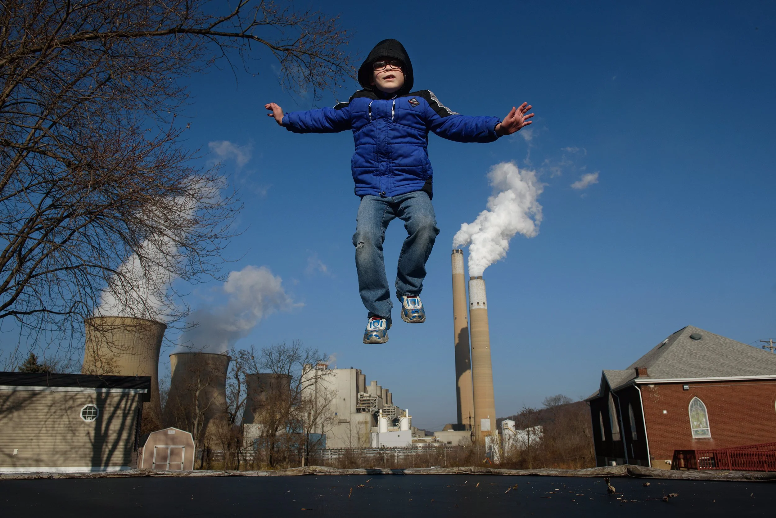  At his home in Shippingport, Pa., a boy jumps on a trampoline near FirstEnergy’s Bruce Mansfield Power Plant. 