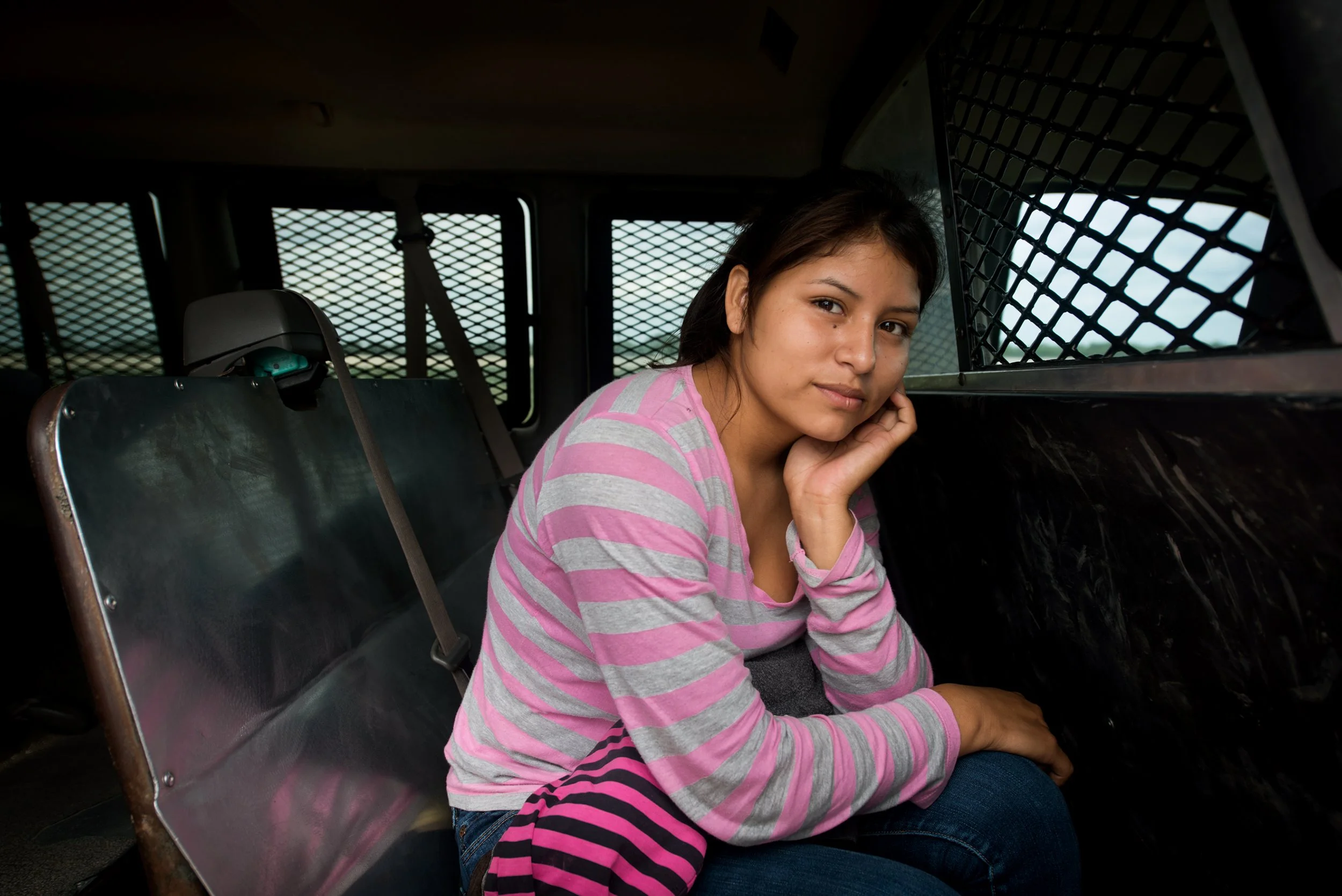  A 16-year-old girl from El Salvador detained in Border Patrol vehicle near McAllen, Texas.  