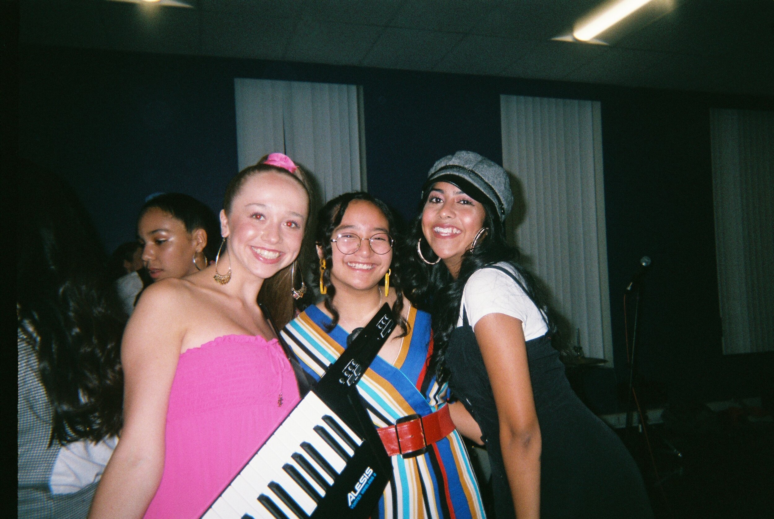 Analiese Bancroft (PM '21), Shannae Bernales (PM '22) and Sidra Villacorta (PM '21) smile for the camera backstage.