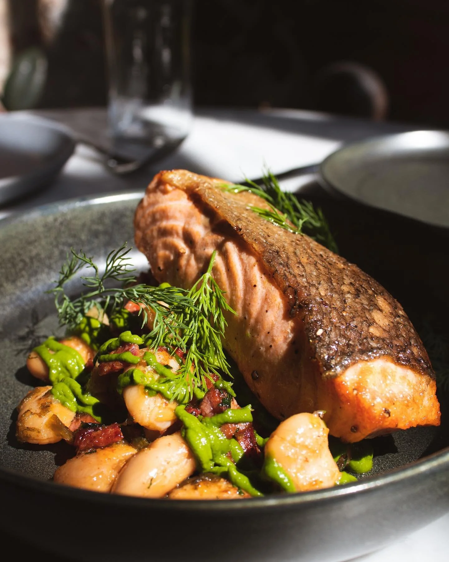 Enjoy the perfect, savory harmony of our pan roasted salmon with andouille and gigante beans 

#cripsyskinsalmon #phillyrestaurants #beans #harpandcrown