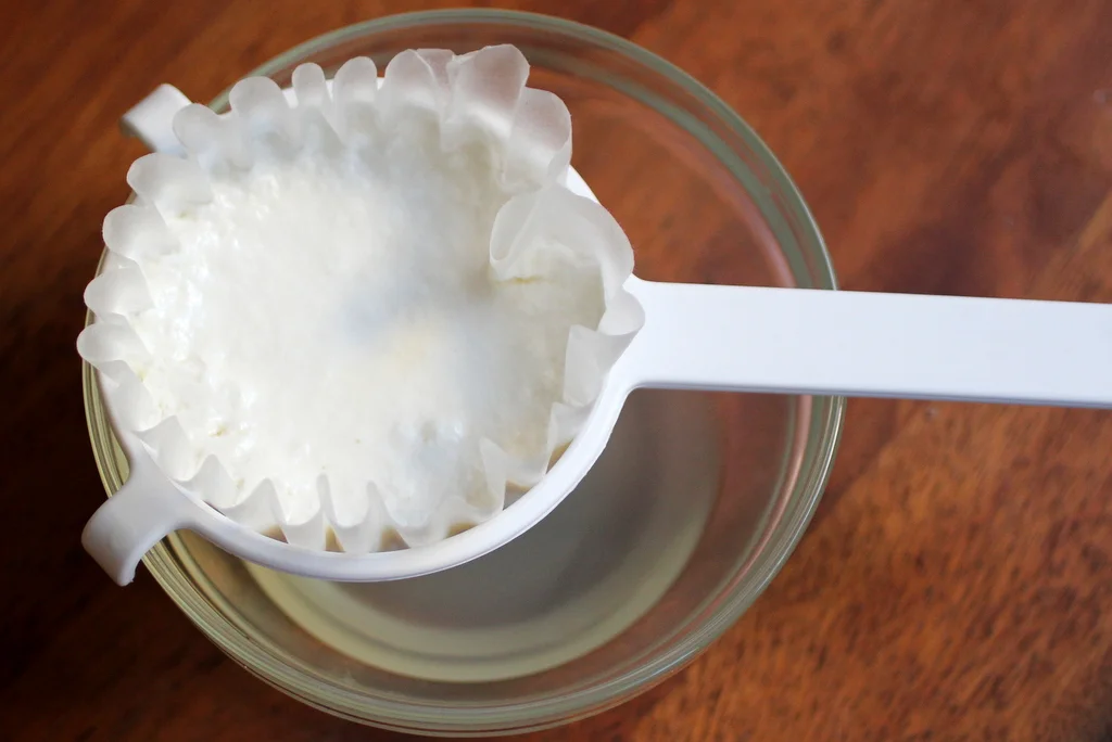 Collect whey by filtering it out of your yogurt
