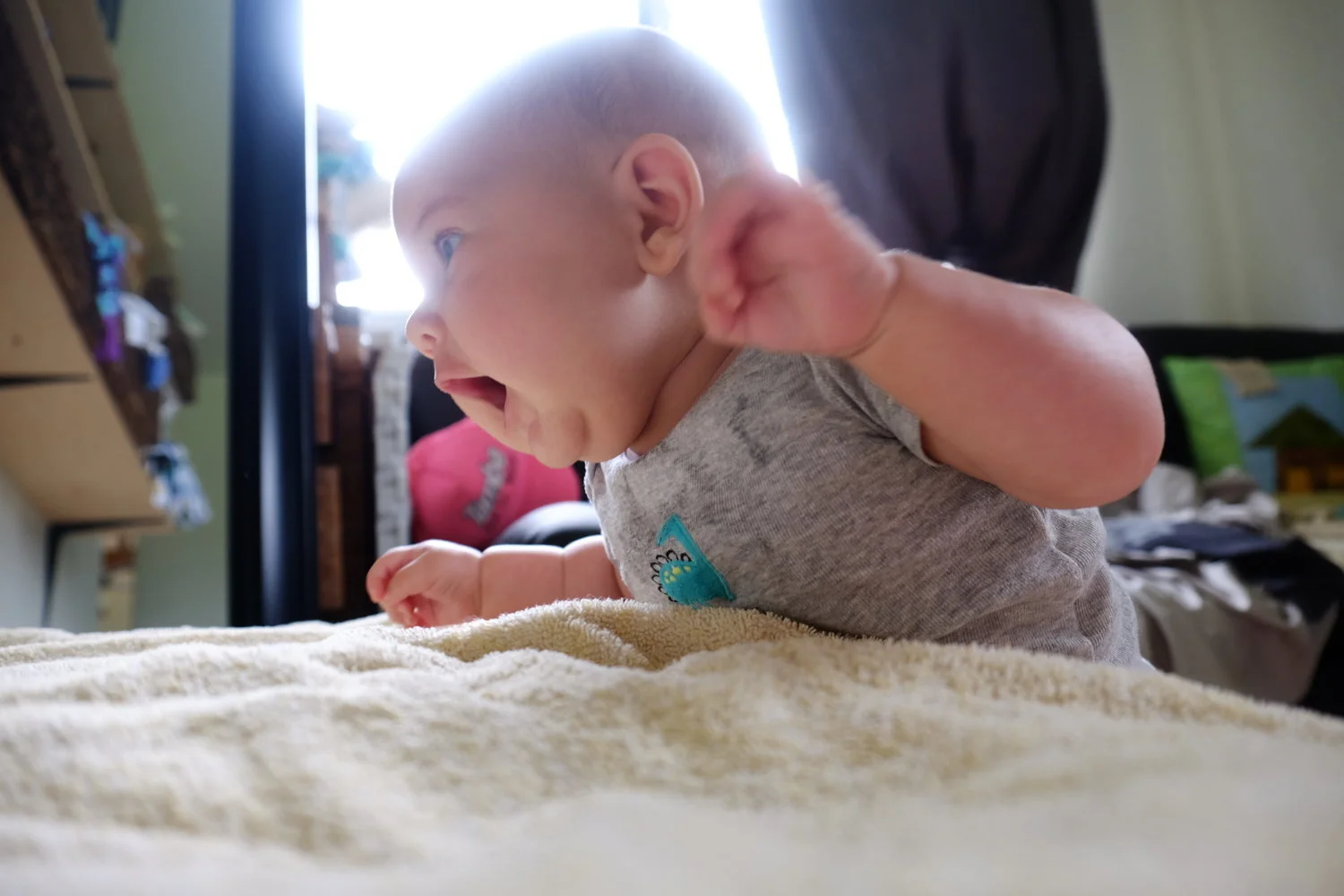 spotting him so he doesn't flip allowed elias to try to climb the bed at 10 weeks, his fav activity. babies need help moving, but allowing them to use their baby energy during the day offers them the opportunity to sleep better at night.