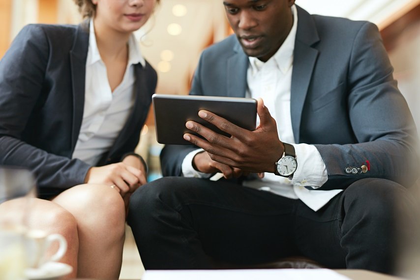 close-up-shot-of-african-business-man-showing-something-on-digital-tablet-to-his-femal-SBI-301326765.jpg