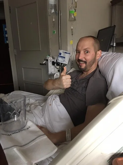 "Tommy…all crazy swollen from chemo, but still managing a thumbs up ….that was his personality. ALWAYS positive. No matter what."