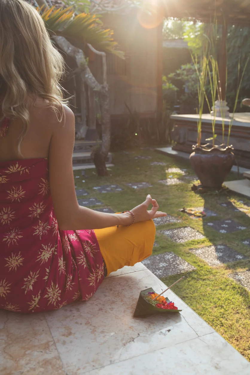 Young-woman-practicing-yoga-in-the-tropical-garden,-691570102_839x1258 (1).jpeg