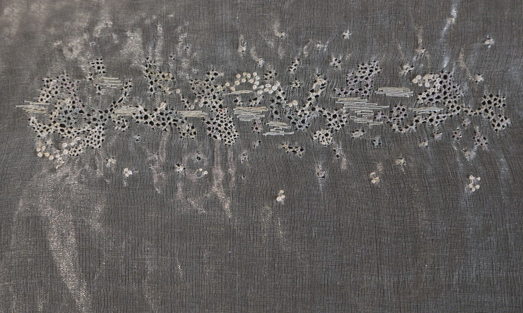 Various handmade embroidery stitches giving a placed abstract embellishment