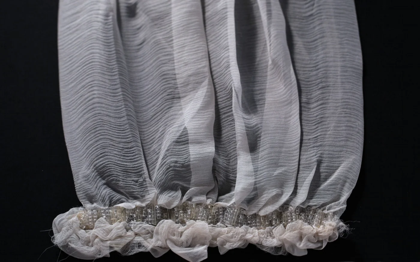 Handwoven beads applied on gathered chiffon.