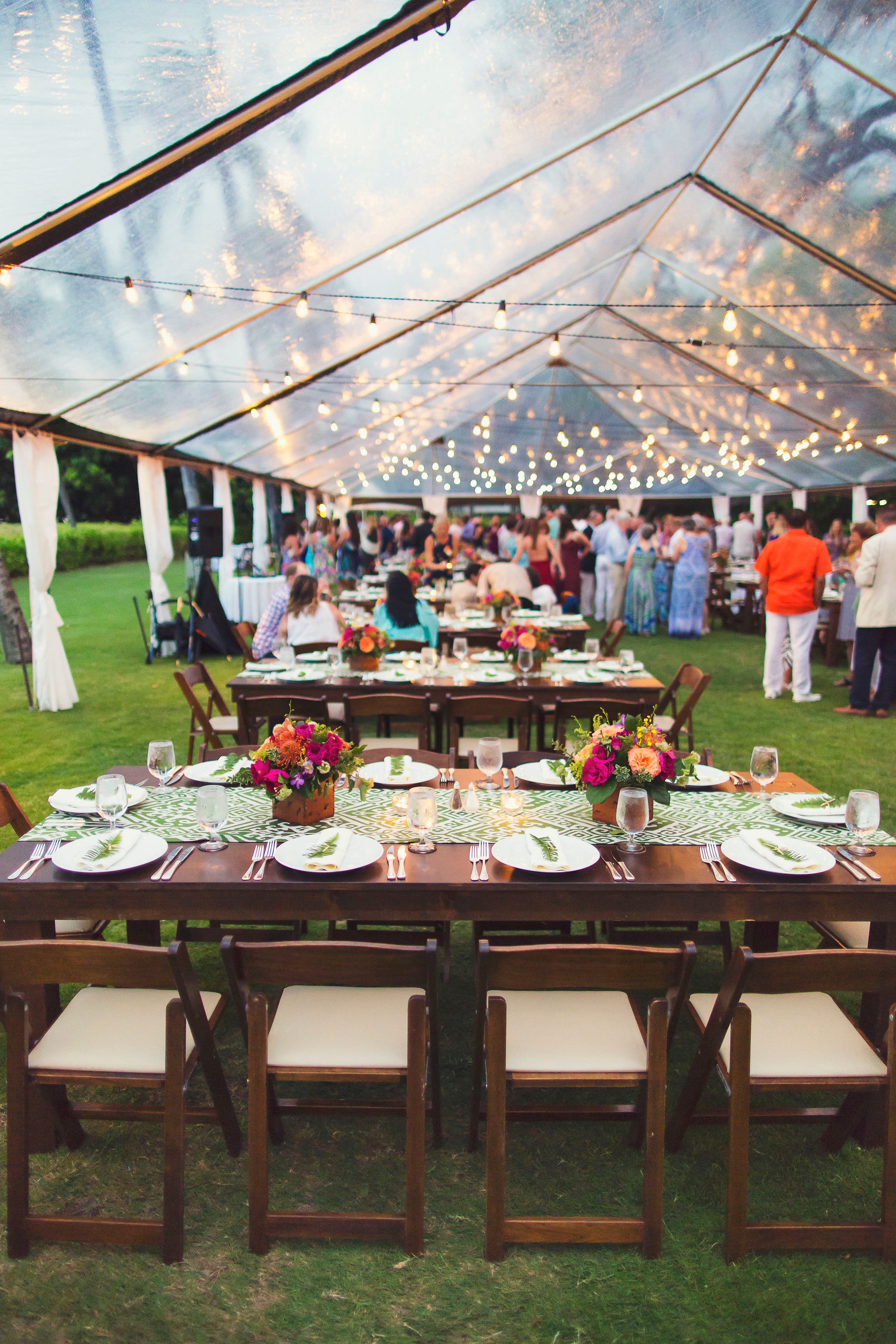 Farm Tables, Dark Wood Padded Folding Chairs, 40x Clear Tent, Market Lighting, and Thin White Leg Draping. Coordination and Design Bliss in Bloom | Photography Fletch Photography . | Location South point lawn Maunakea Hotel