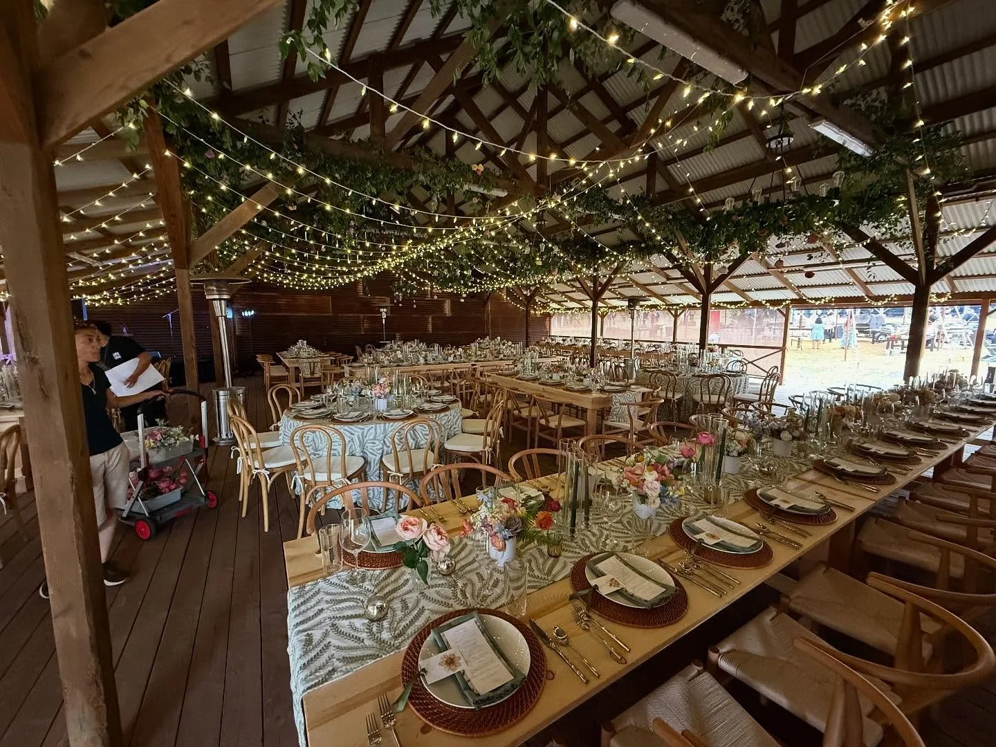 Upscale rustic wedding at Waikii Ranch. Featuring our new natural farm tables, bent wood &amp; wishbone &amp; cross back chairs, 30x &amp; 40x sail cloth tents, patio heaters, twinkle lighting canopy, dark wood farm tables, wine barrels, teak dance f