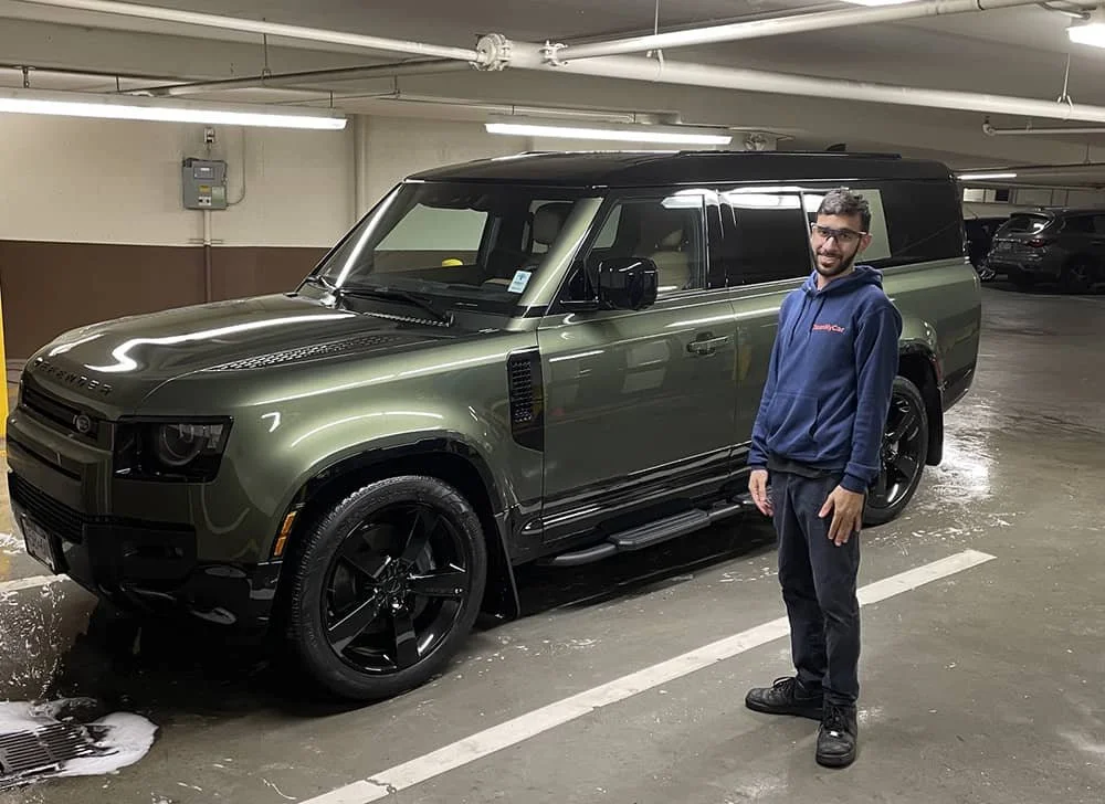 Green Land Rover SUV after exterior detailing service in an underground parking garage in Vancouver.