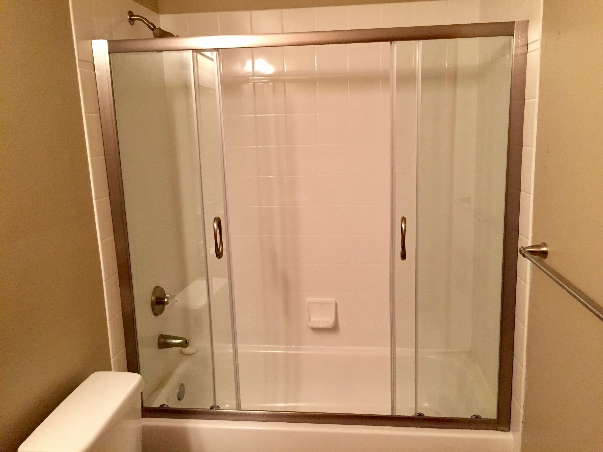 Sliding glass bathtub door