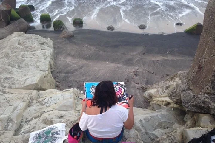 Miranda at the beach creating art.
