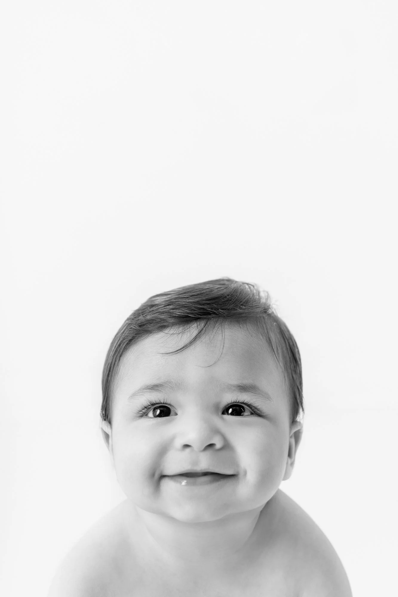 Baby with thick brown hair and big beautiful eyes smiles in a Northern New Jersey studio session with Nicole Hawkins Photography. baby with thick brown hair baby boy portrait studio family photos #nicolehawkinsphotography #nicolehawkinsbabies #newje