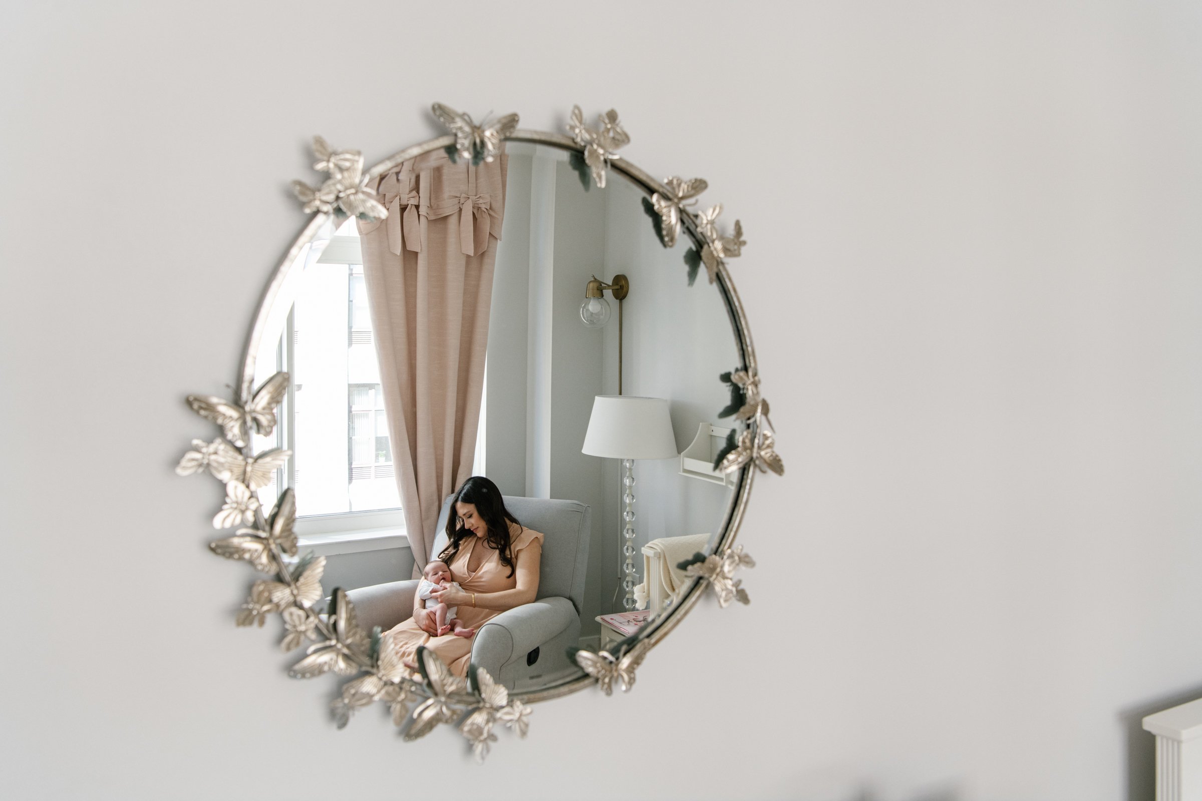  Nicole Hawkins Photography captures a mother sitting on the baby recliner taking care of her new baby in a mirror in New Jersey. mother captured in a mirror motherhood mother's love baby girl and mommy new mommy #nicolehawkinsphotography #nicolehawk