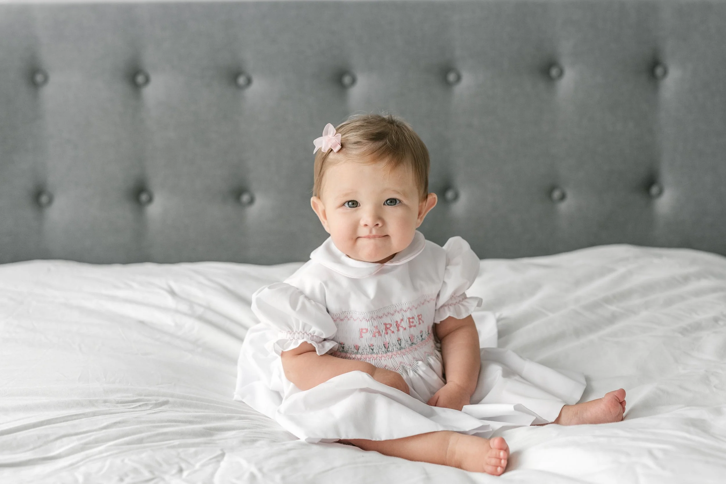  An in-home session with a six-month little girl with embroidered name dress with Nicole Hawkins Photography. personalized little girl dress baby #nicolehawkinsphotography #newjerseyphotographers #familyphotographer #6monthportraits #NJfamilyphotos 