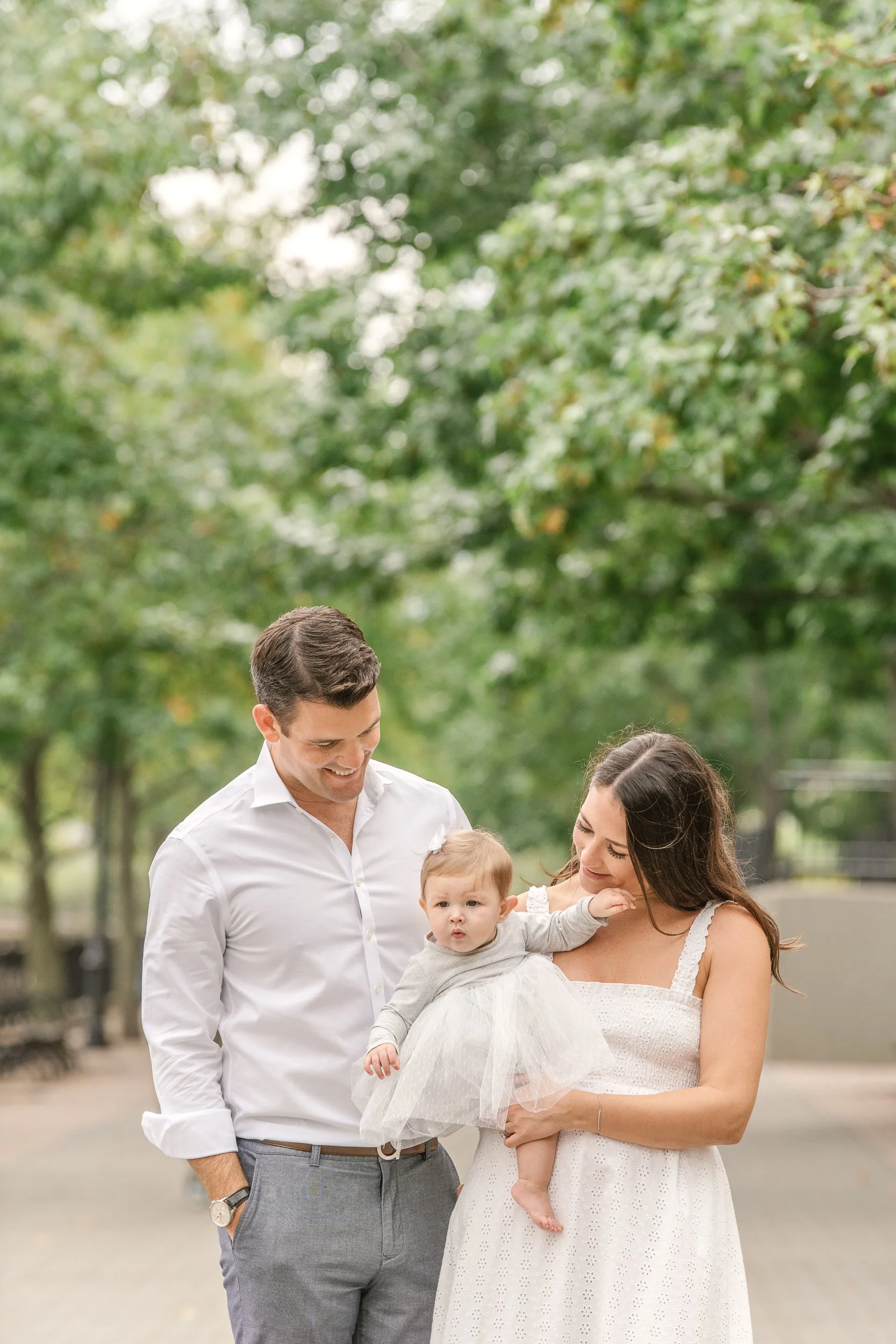  In New Jersey, in the summer a young family enjoys their young daughter by Nicole Hawkins Photography. New Jersey photos summer dress family pics #nicolehawkinsphotography #newjerseyphotographers #familyphotographer #6monthportraits #NJfamilyphotos 