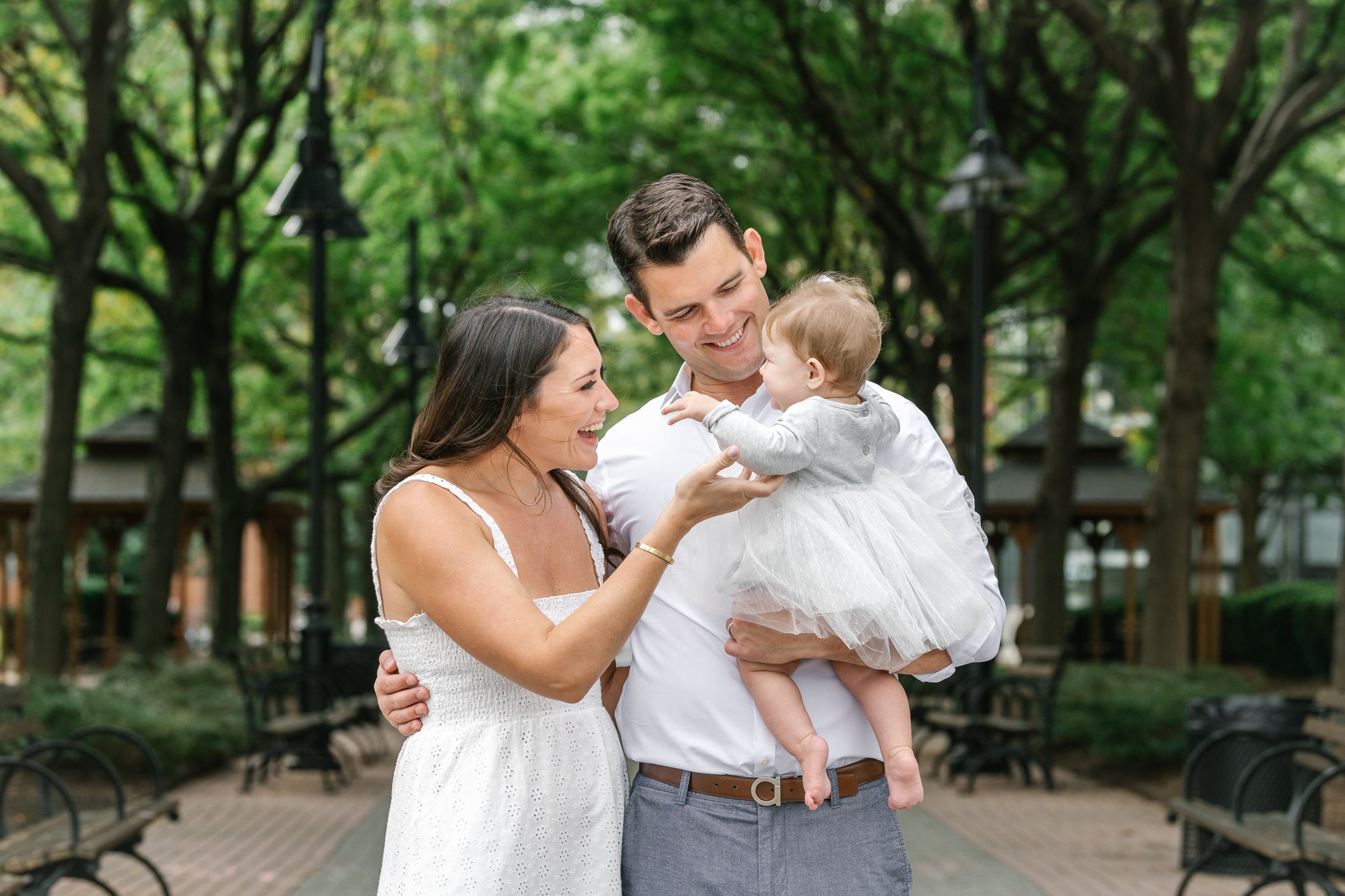  Nicole Hawkins Photography captures a baby girl with her mother in father in a Hoboken park. men's family attire ideas New Jersey family pics #nicolehawkinsphotography #newjerseyphotographers #familyphotographer #6monthportraits #NJfamilyphotos 