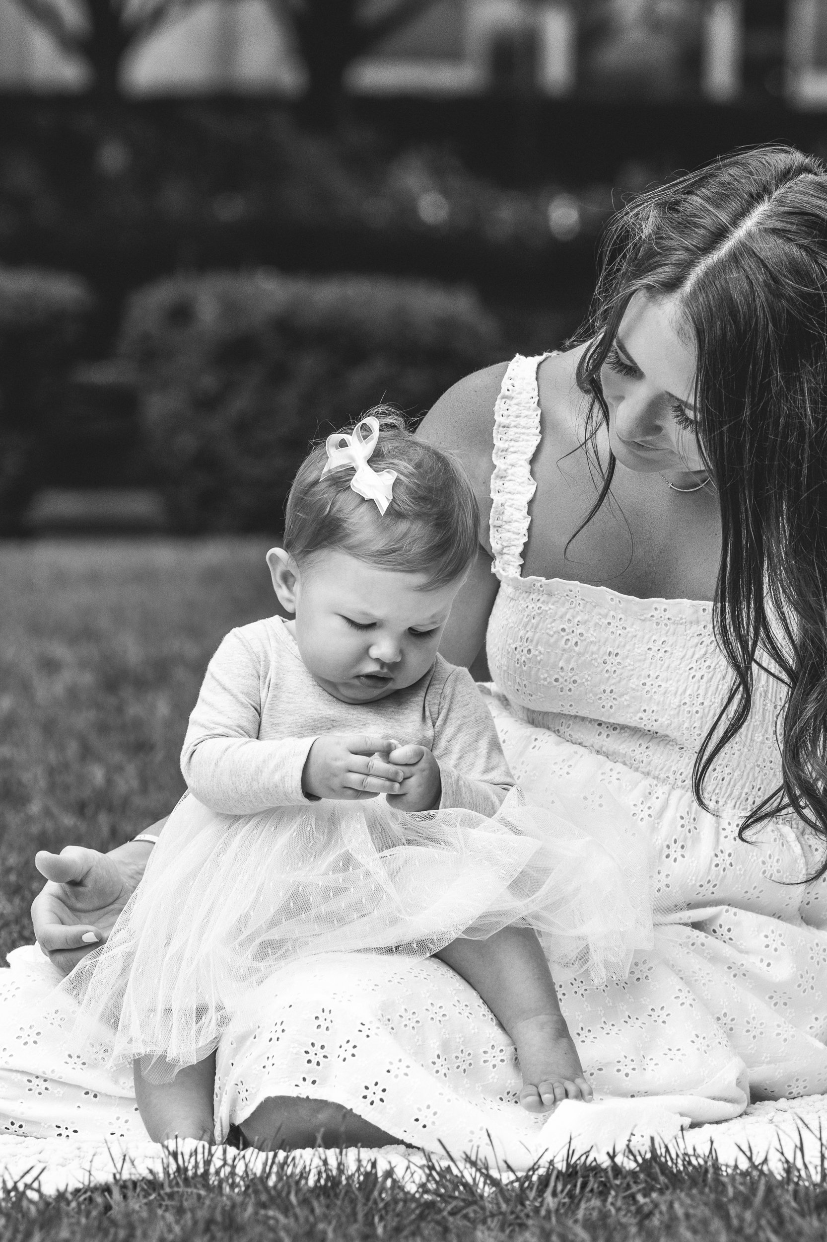  Black and white portrait of a mother and daughter on a picnic blanket in New Jersey by Nicole Hawkins Photography. black and white mother-baby pic #nicolehawkinsphotography #newjerseyphotographers #familyphotographer #6monthportraits #NJfamilyphotos