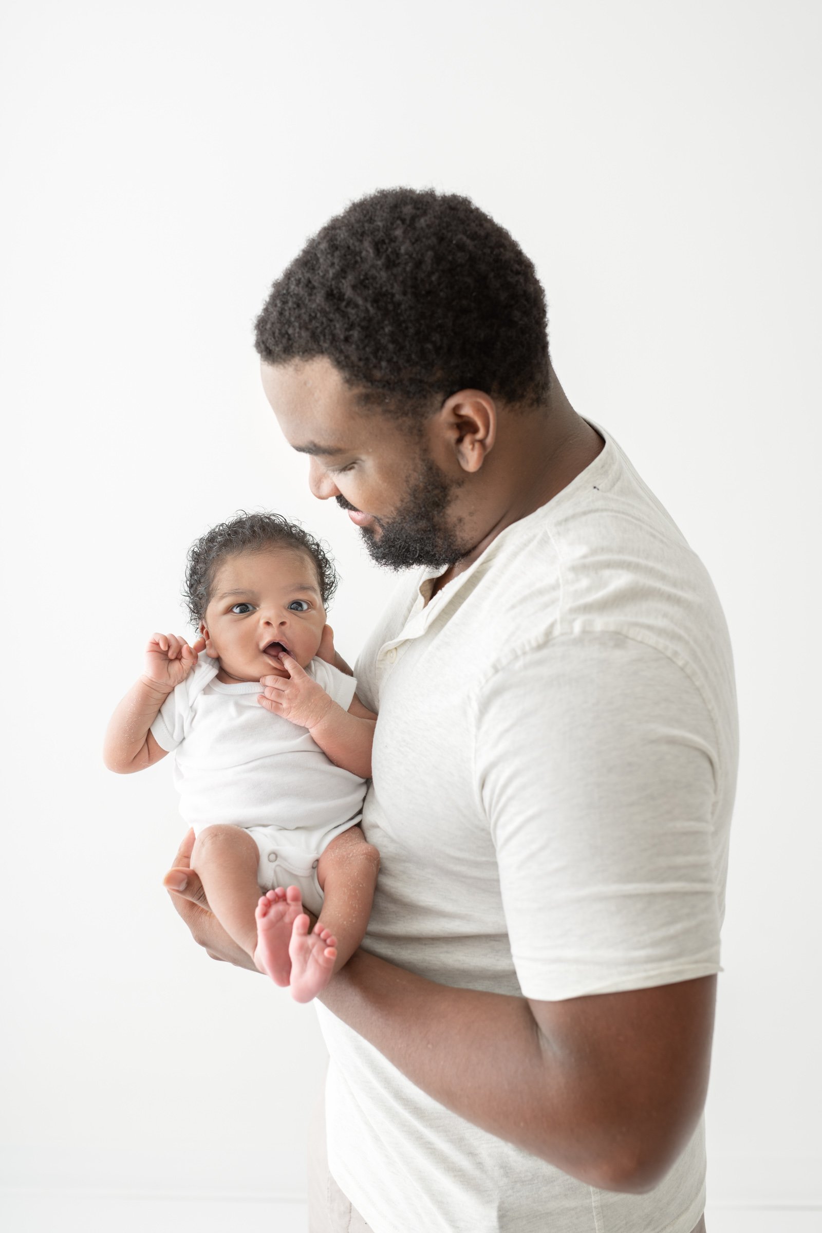  Newborn portraits of a baby with his father in a New Jersey studio by Nicole Hawkins Photography. bright newborn studio photo father baby #nicolehawkinsphotography #NJbabyphotography #newbornportraits #NewJerseyStudioPhotography #newbornsession 