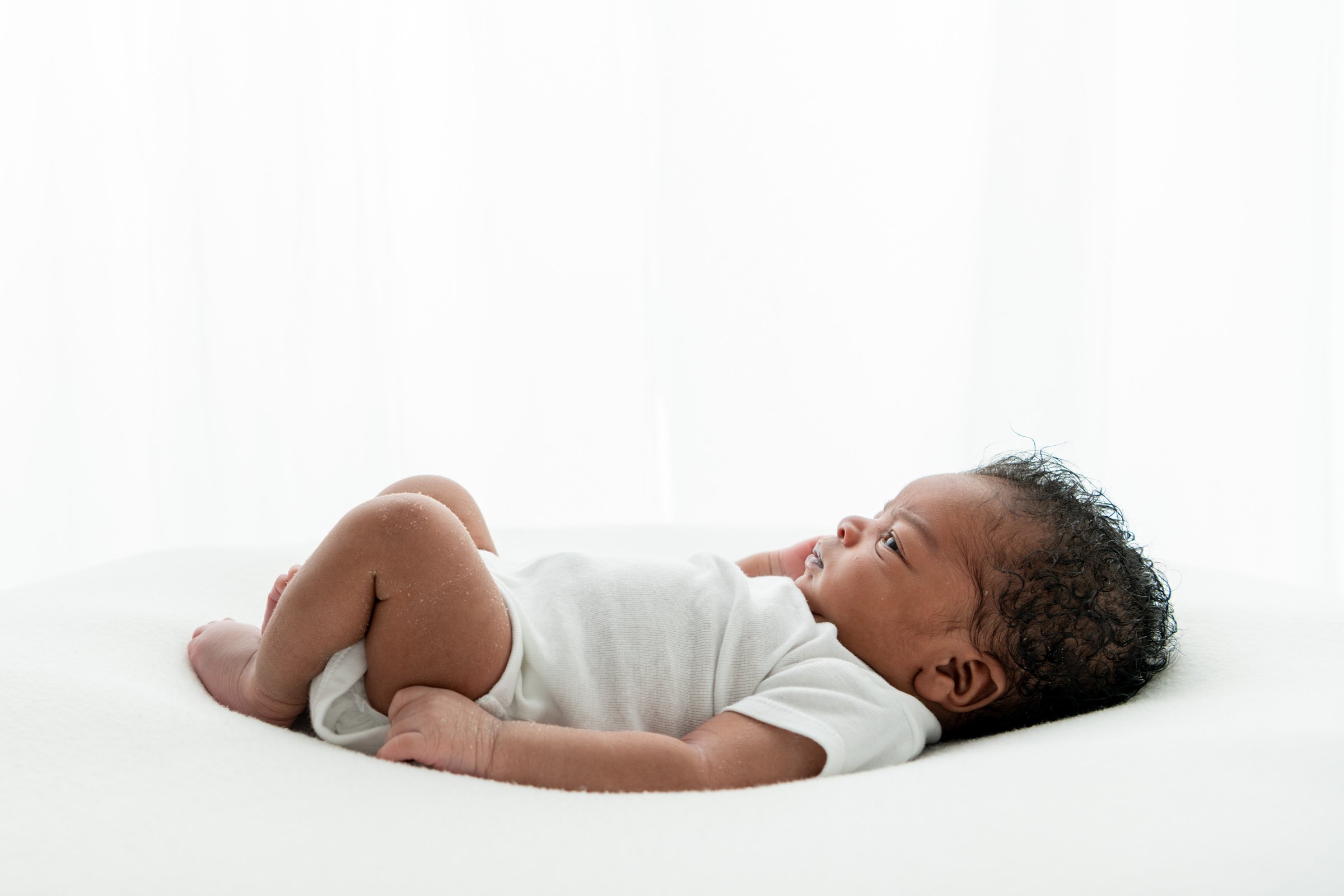  Nicole Hawkins Photography of the New Jersey area captures a profile portrait of a newborn in a studio. side profile of baby studio portraits #nicolehawkinsphotography #NJbabyphotography #newbornportraits #NewJerseyStudioPhotography #newbornsession 
