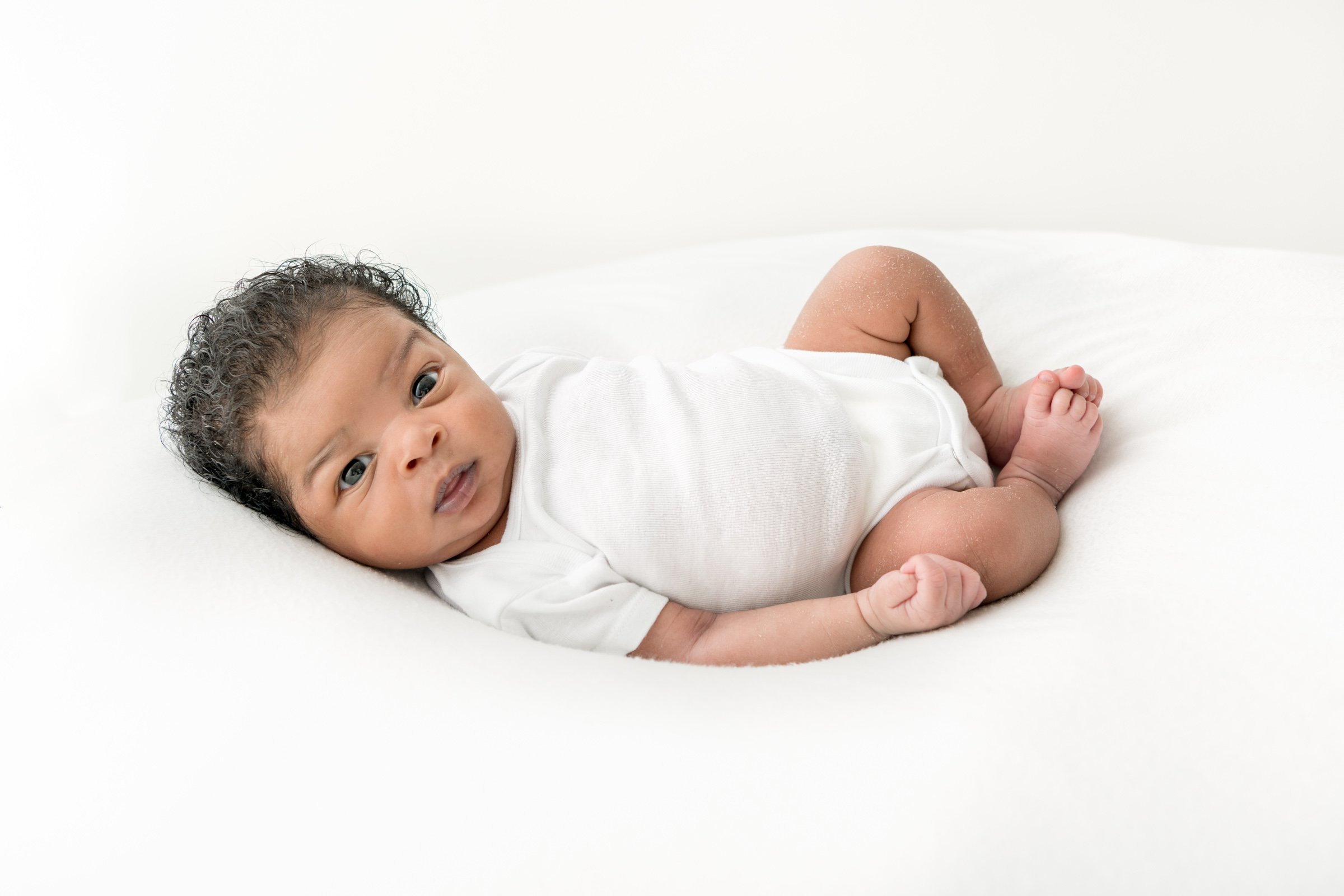  In an all-white studio in New Jersey, Nicole Hawkins Photography captures photography of a baby on a white pillow. all white studio sessions #nicolehawkinsphotography #NJbabyphotography #newbornportraits #NewJerseyStudioPhotography #newbornsession 
