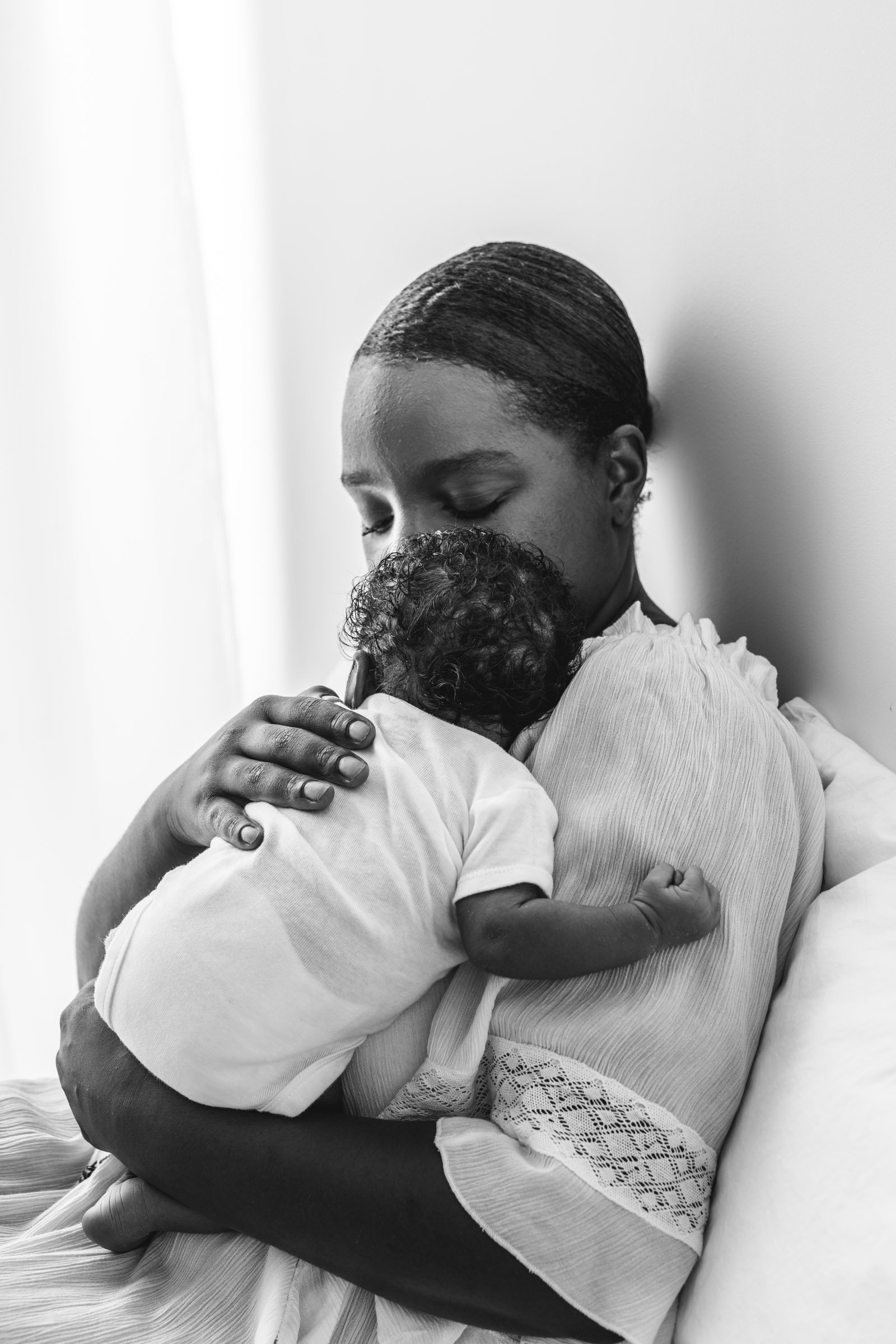  Nicole Hawkins Photography captures a black and white portrait of a mother and her newborn in a studio in NJ. NJ studio photographers newborns #nicolehawkinsphotography #NJbabyphotography #newbornportraits #NewJerseyStudioPhotography #newbornsession