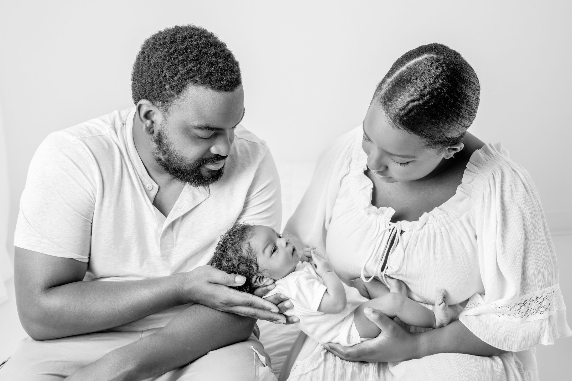  During an all-white studio session, Nicole Hawkins Photography captures a portrait of a new family of three. family of three new parents #nicolehawkinsphotography #NJbabyphotography #newbornportraits #NewJerseyStudioPhotography #newbornsession 