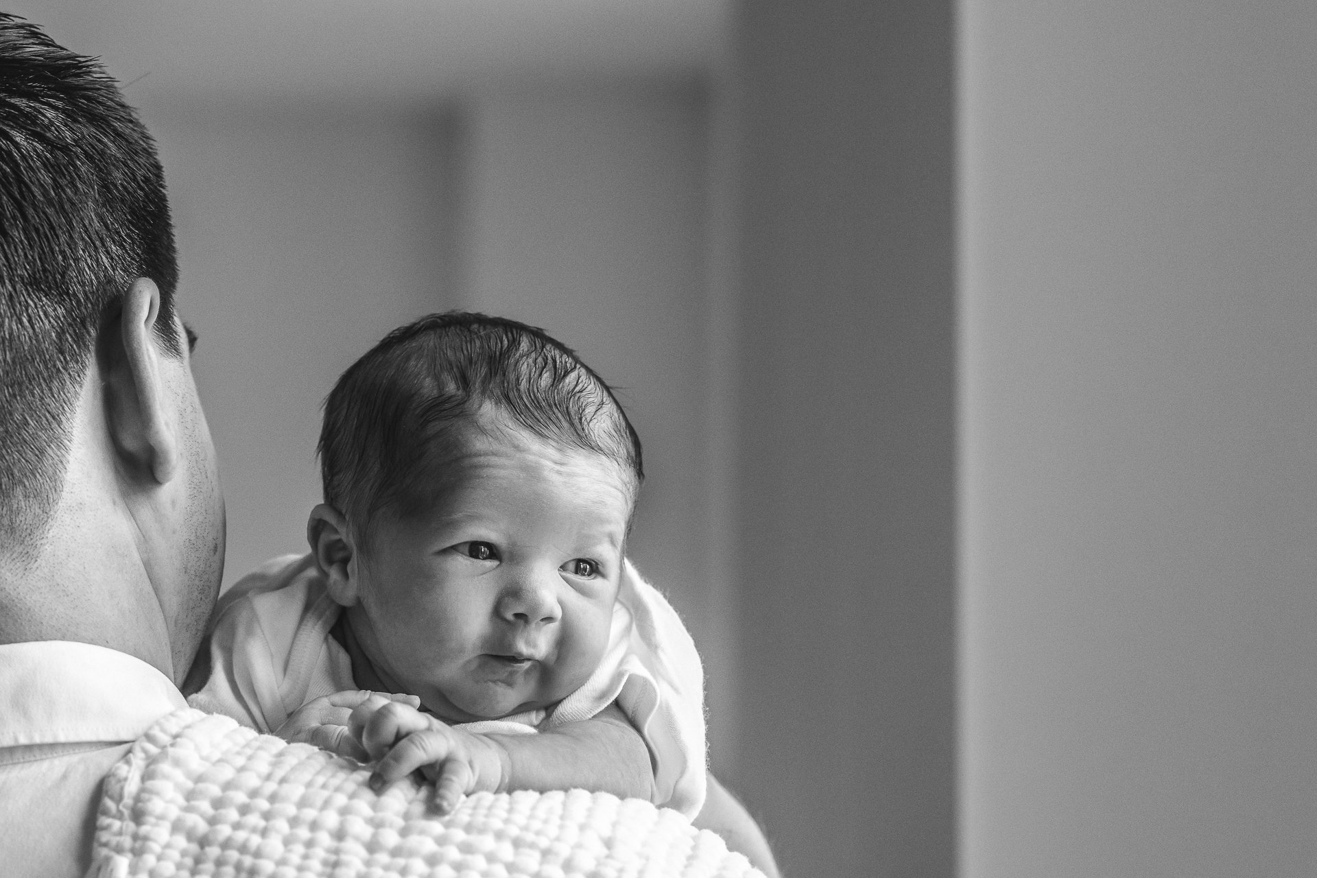  Nicole Hawkins Photography captures a newborn boy with black hair and eyes open. cute newborn pics newborn in-home portraits NYC newborn photos #nicolehawkinsphotography #NYCbabyphotography #newbornportraits #NewYorkStudioPhotography #newbornsession