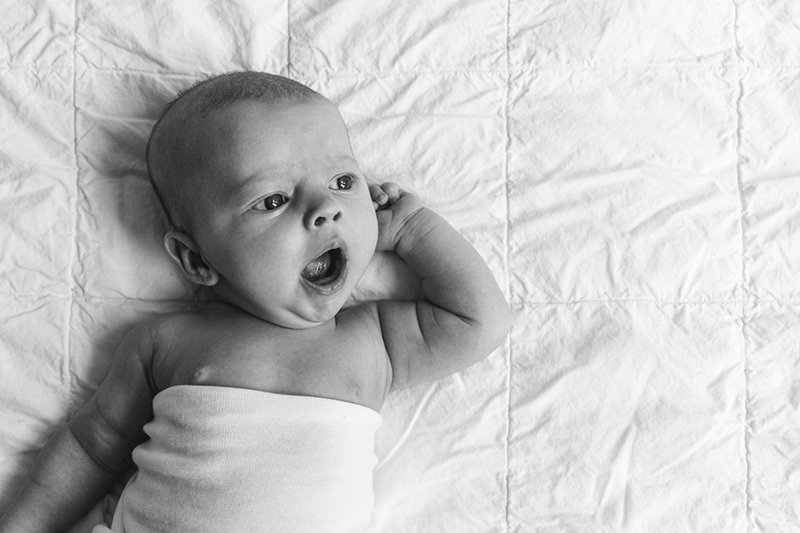  Nicole Hawkins Photography of the New Jersey area captures a black and white portrait of a baby yawning. yawning newborn portraits #nicolehawkinsphotography #NJstudionewborns #newbornsession #studionewborns #NJnewbornphotographers #NJphotographers 