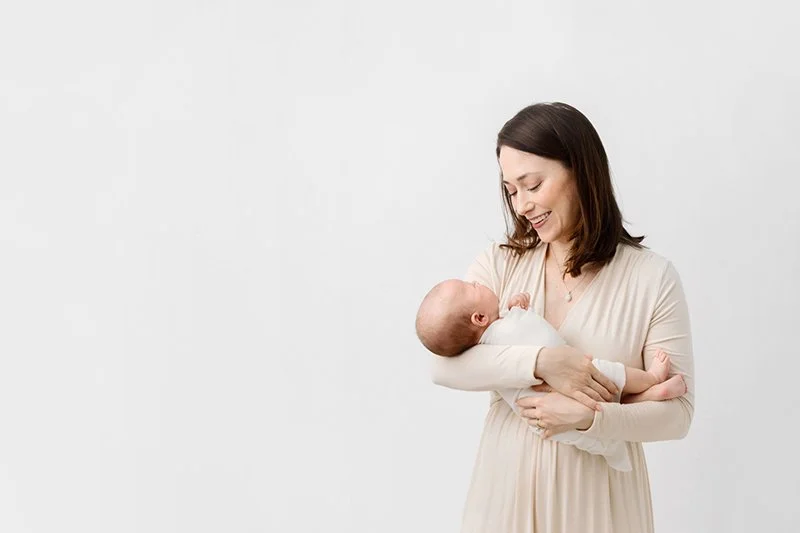  A mother and baby in a bright white studio in New Jersey during a newborn session with Nicole Hawkins Photography. bright airy studio #nicolehawkinsphotography #NJstudionewborns #newbornsession #studionewborns #NJnewbornphotographers #NJphotographer