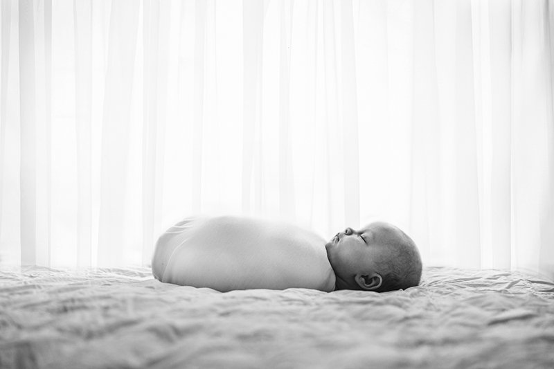  During a newborn session, Nicole Hawkins Photography captures a newborn swaddled in front of a bright window. swaddled newborn photos #nicolehawkinsphotography #NJstudionewborns #newbornsession #studionewborn #NJnewbornphotographers #NJphotographers