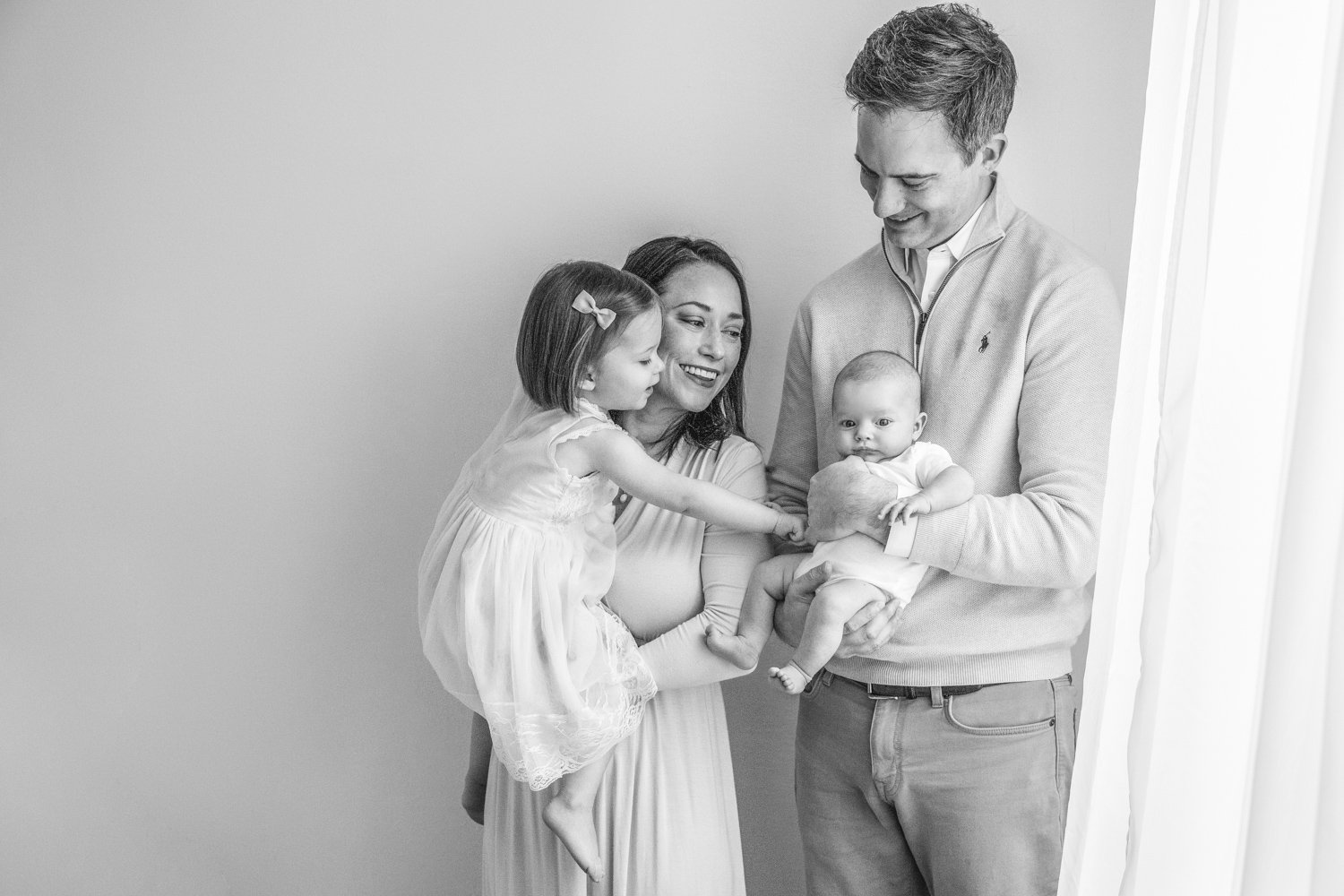  A black and white portrait of a family of four with a newborn by Nicole Hawkins Photography. family of four newborn portrait #nicolehawkinsphotography #NJstudionewborns #newbornsession #studionewborns #NJnewbornphotographers #NJphotographers 